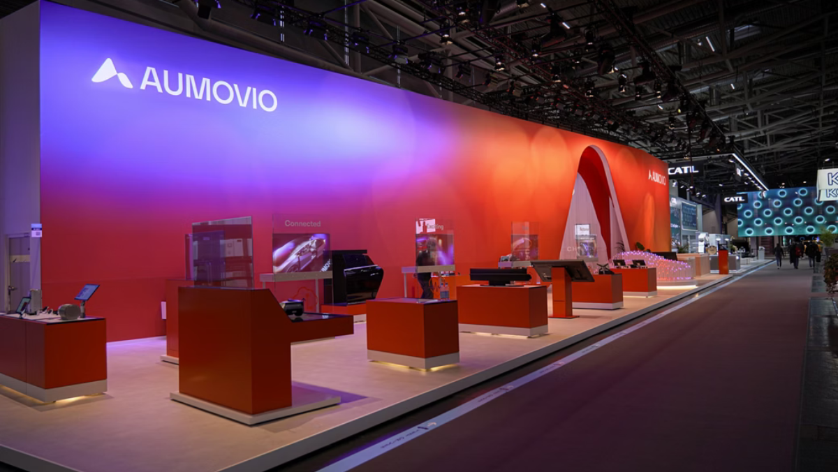 Aumovio exhibition booth showcasing automotive software displays and connected vehicle technologies.