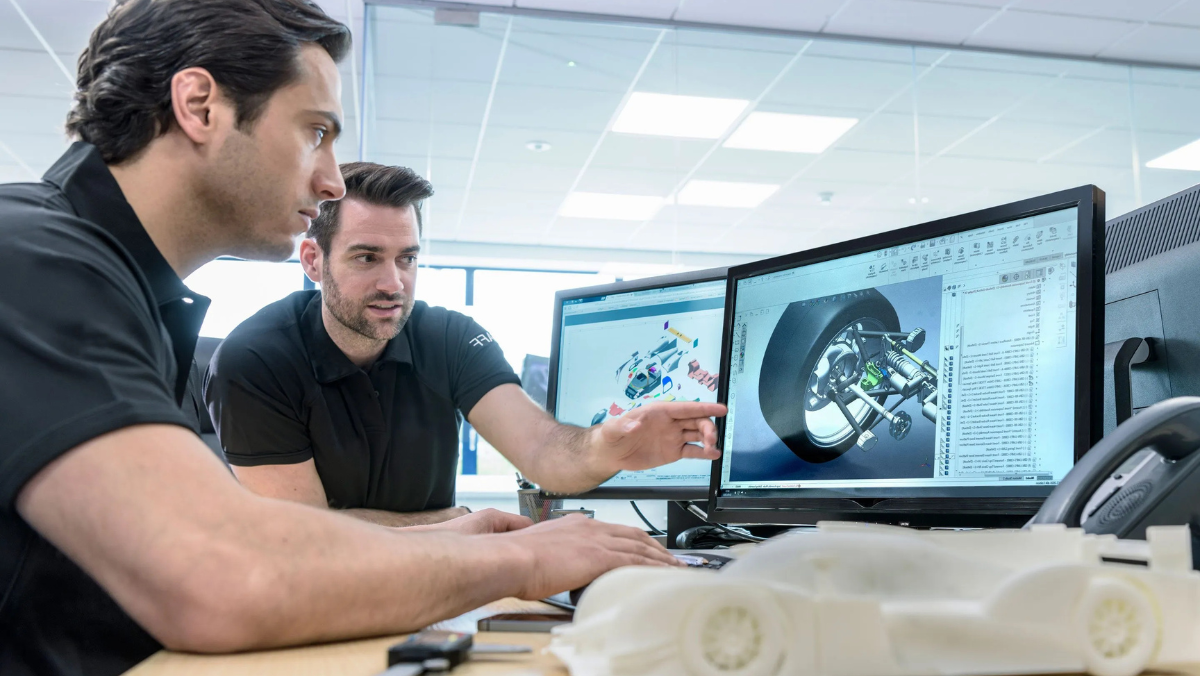 Engineers analysing software-defined vehicle systems using CAD tools