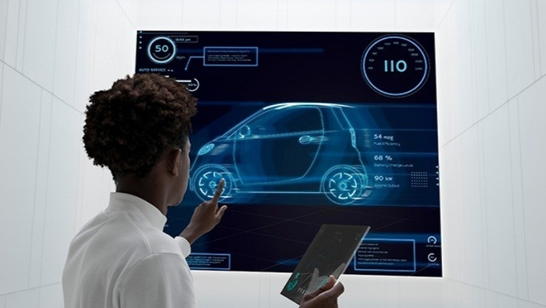 Person interacting with digital vehicle interface displaying car data