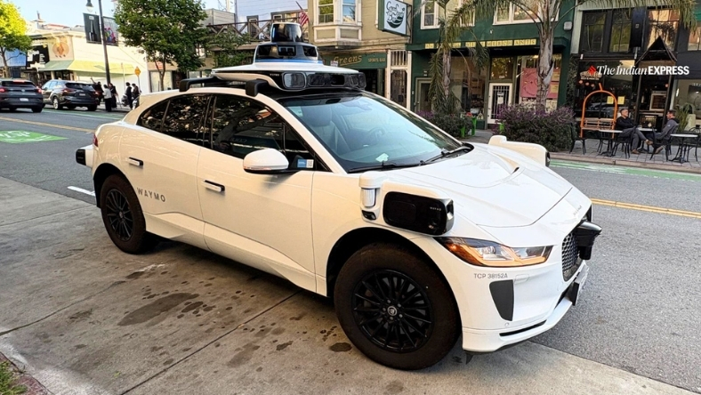 Waymo self-driving car with rooftop lidar on city street